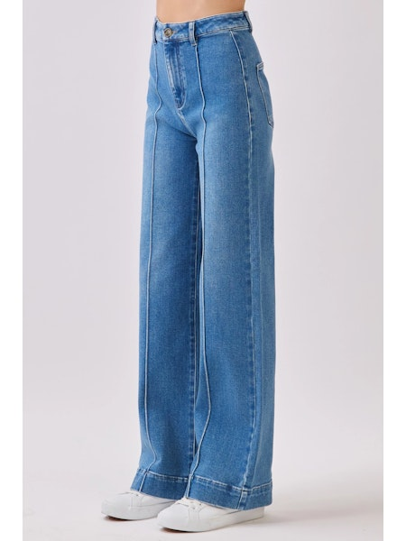 Blue jeans worn by a person on a white background