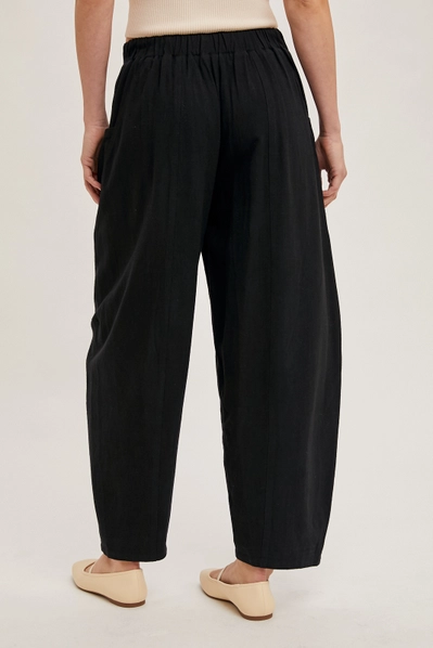 black barrel pants from behind against white background