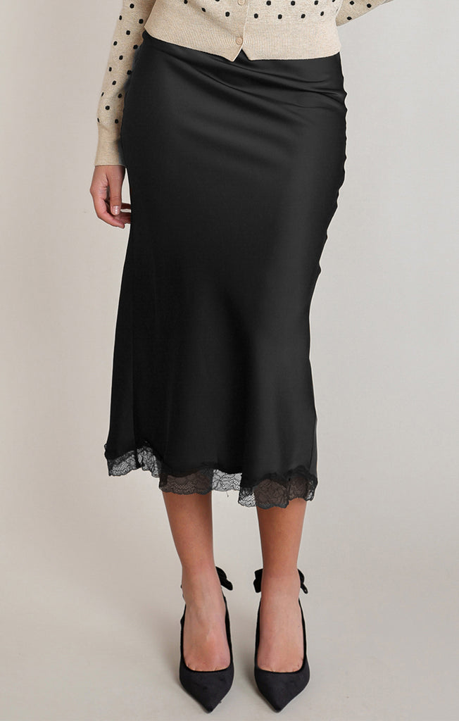 woman in black midi skirt with lace detail at the bottom