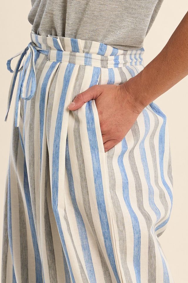 Striped pants with a pocket detail on a neutral background
