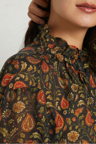 close photo of woman in patterned blouse