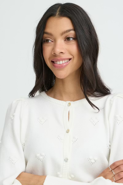 Woman wearing a white blouse with a plain background
