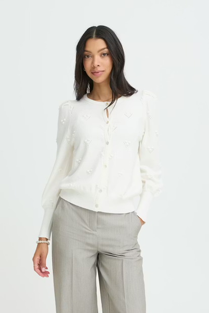 Woman wearing a white blouse and light gray pants on a white background
