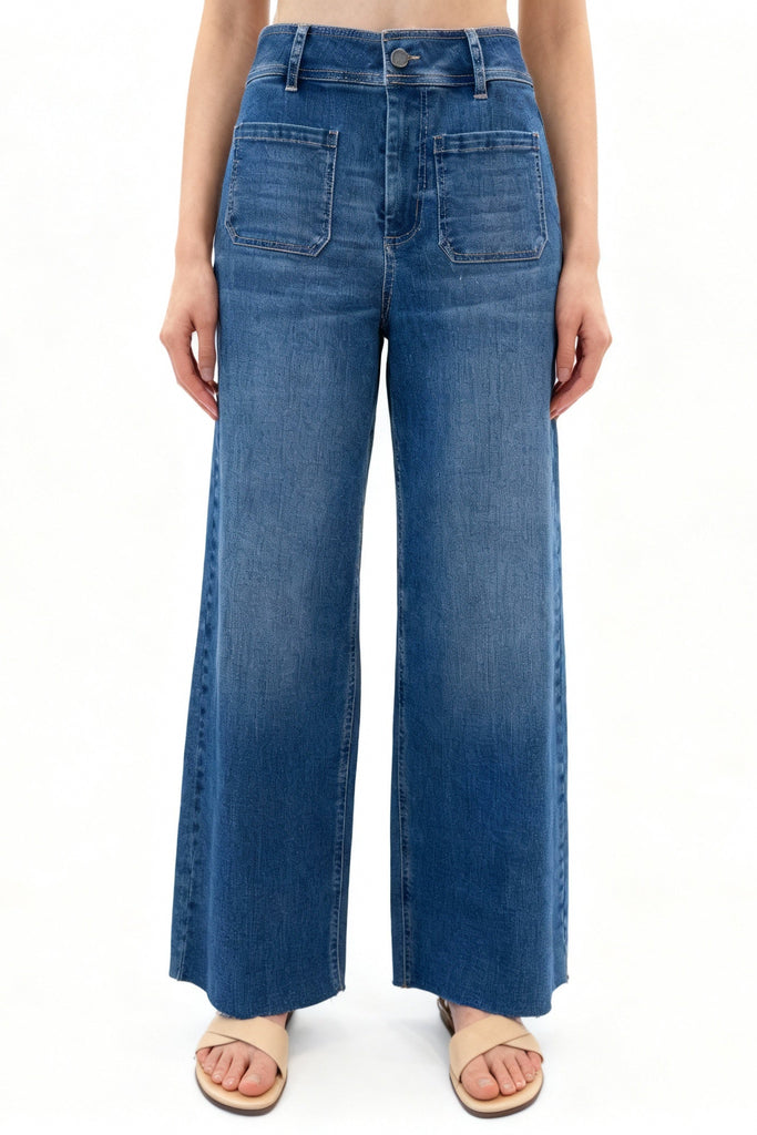 Blue wide-leg jeans worn by a person on a white background