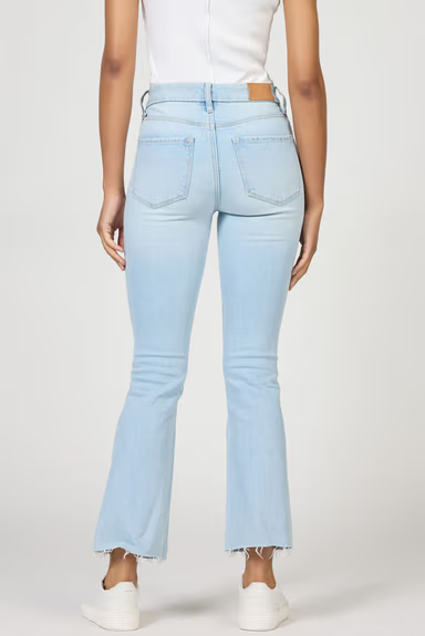 Light blue jeans worn by a person on a white background