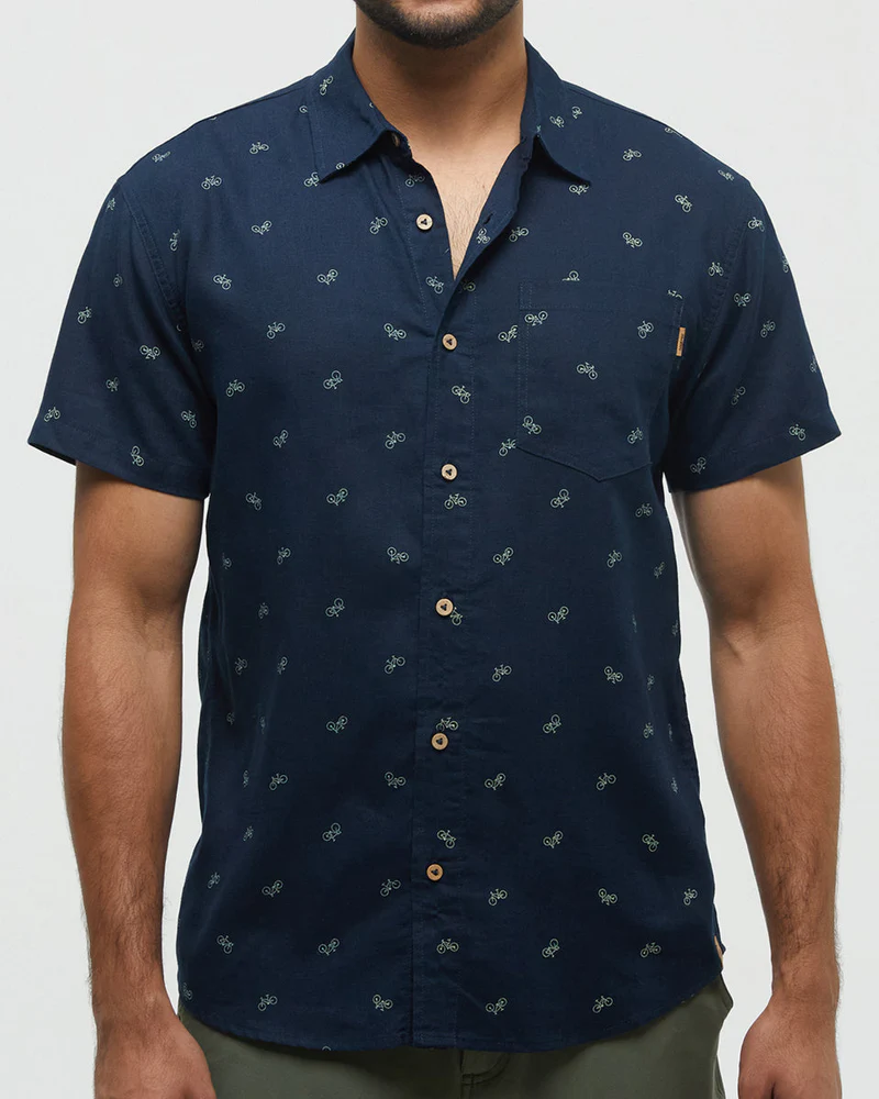 Man wearing a navy blue patterned shirt on a white background