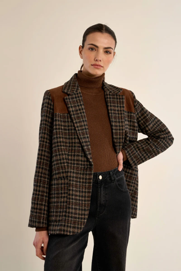 woman in plaid jacket and dark pants