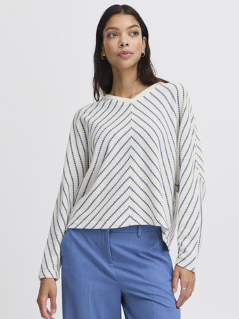 woman in blue and white striped top and blue jeans against white background