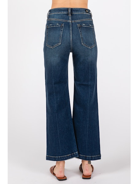 Blue jeans worn by a person on a white background