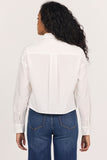back of woman in white cropped blouse  against white background
