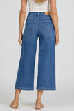 woman wearing blue jeans against a white background