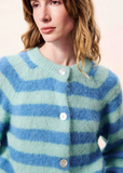 Woman wearing a blue and green striped cardigan against a plain background