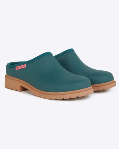 teal clog shoes against white background
