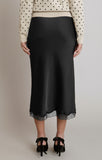 woman in black midi skirt with lace detail at the bottom