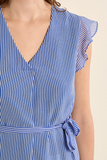 Blue and white striped dress with ruffled sleeves on a beige background