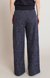 Navy blue patterned pants worn by a person on a beige background