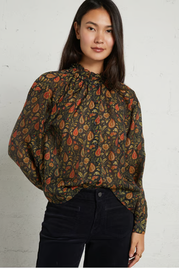 woman in patterned blouse