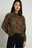 woman in patterned blouse