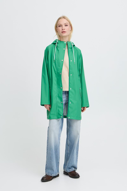 Person wearing a green raincoat on a white background