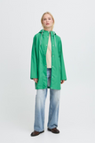 Person wearing a green raincoat on a white background