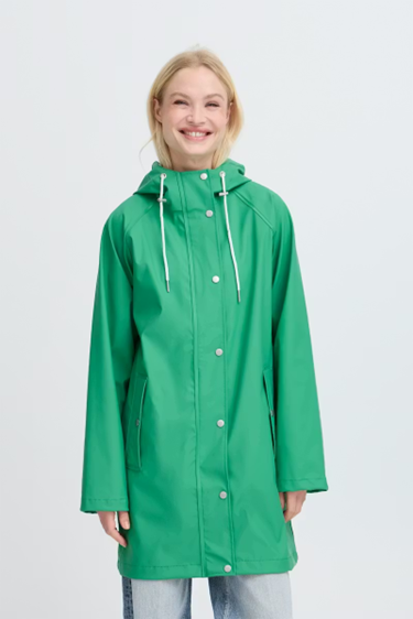Woman wearing a green raincoat on a white background
