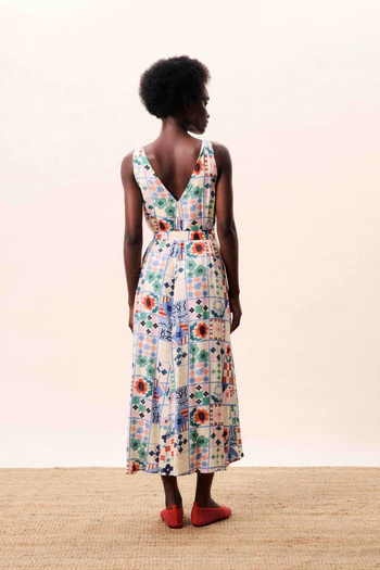 Woman wearing a floral dress with a plain background