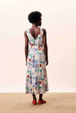 Woman wearing a floral dress with a plain background