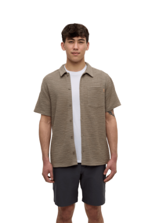 Man wearing a brown short-sleeve shirt over a white t-shirt with black shorts on a white background