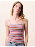 Woman wearing a colorful striped tank top against a plain background