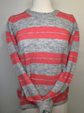 Red and gray striped sweater on a mannequin against a plain background