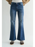dark flare jeans against a white background