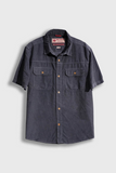 Navy short-sleeve shirt with button details on a light gray background