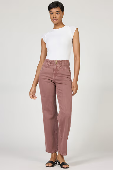 Woman wearing a white top and pink pants on a white background