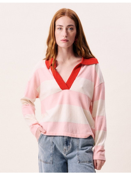 Woman wearing a pink and red striped shirt with a plain background