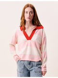 Woman wearing a pink and red striped shirt with a plain background