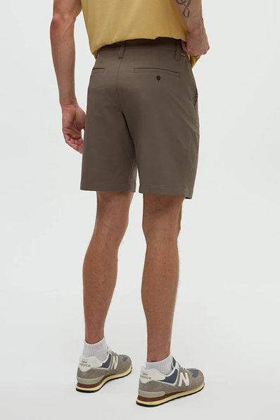 Person wearing brown shorts on a white background