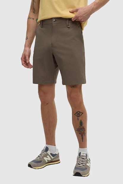 Person wearing brown shorts on a white background