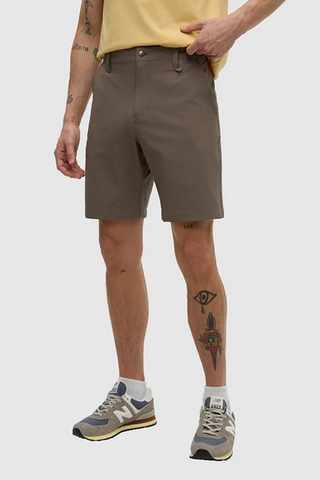 Person wearing brown shorts on a white background