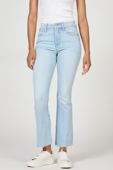 Light blue jeans worn by a person on a white background