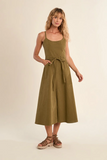 Woman wearing a green dress on a beige background