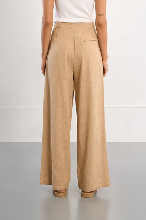 Beige wide-leg pants worn by a person on a plain background