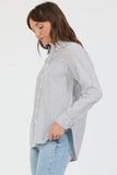 Woman wearing a striped shirt and jeans on a white background