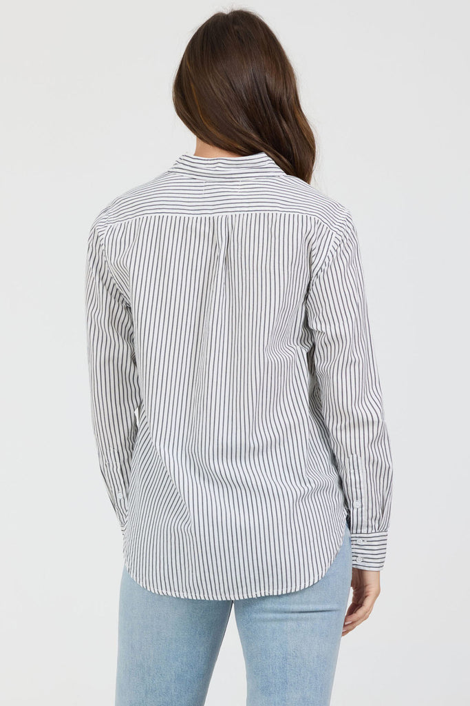 Person wearing a striped shirt and light blue jeans on a white background