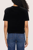 back of woman in black velvet, boxy top
