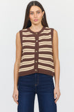 A woman modeling a sleeveless knit vest with horizontal brown, beige, and white stripes, paired with dark blue jeans against a plain white background.