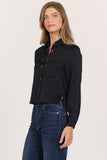 woman in black, cropped button up blouse and jeans