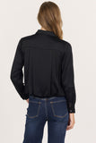 woman in black, cropped button up blouse and jeans