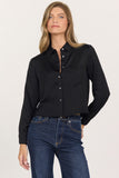 woman in black, cropped button up blouse and jeans
