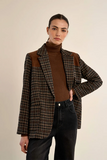 woman in plaid jacket and dark pants