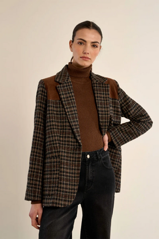 woman in plaid jacket and dark pants